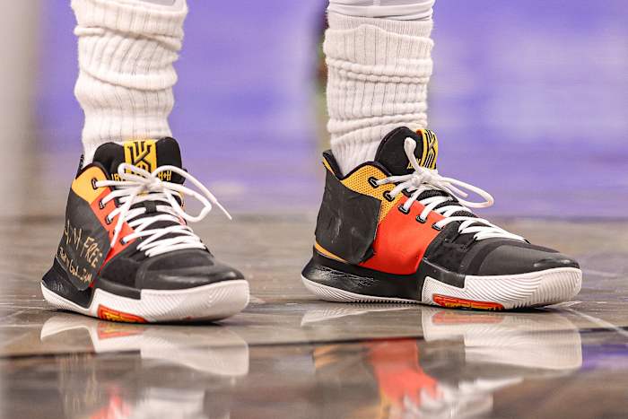 View of black and red Nike Kyrie shoes.